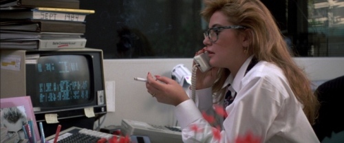 Demi Moore smoking at her desk in the hit 80s movie, St. Elmo's Fire.